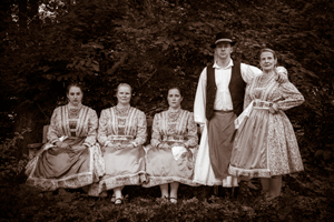 Tisza posing in Rábaközi costumes for an old-fashioned, sepia photo
